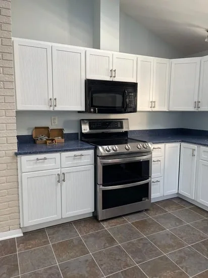 Kitchen cabinets refinish showing updated white cabinetry and modern finish