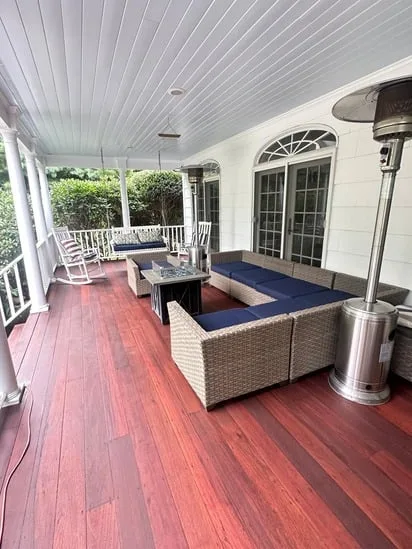 Ipe wood deck restoration with reinstalled outdoor furniture on restored surface