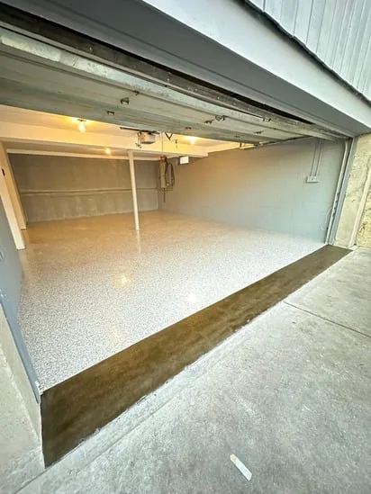 Garage epoxy floor installation completed with a smooth, seamless epoxy-coated surface.