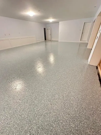Epoxy garage floor installation highlighting finished surface from wide-angle view