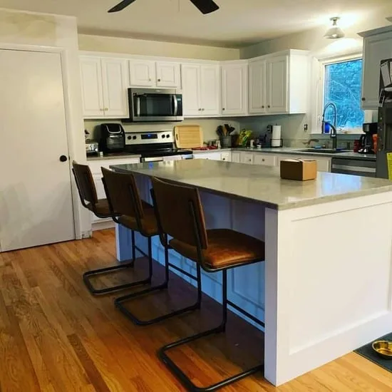 Kitchen cabinet refinishing with cohesive cabinetry and modern hardware